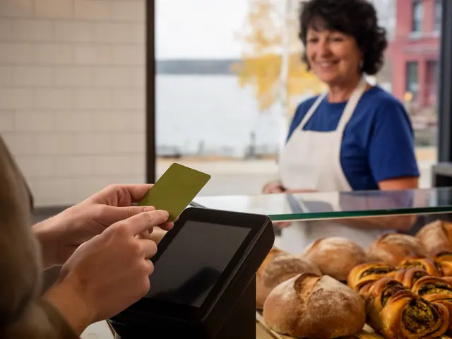 A customer taps a card on a counter terminal at a small bakery.